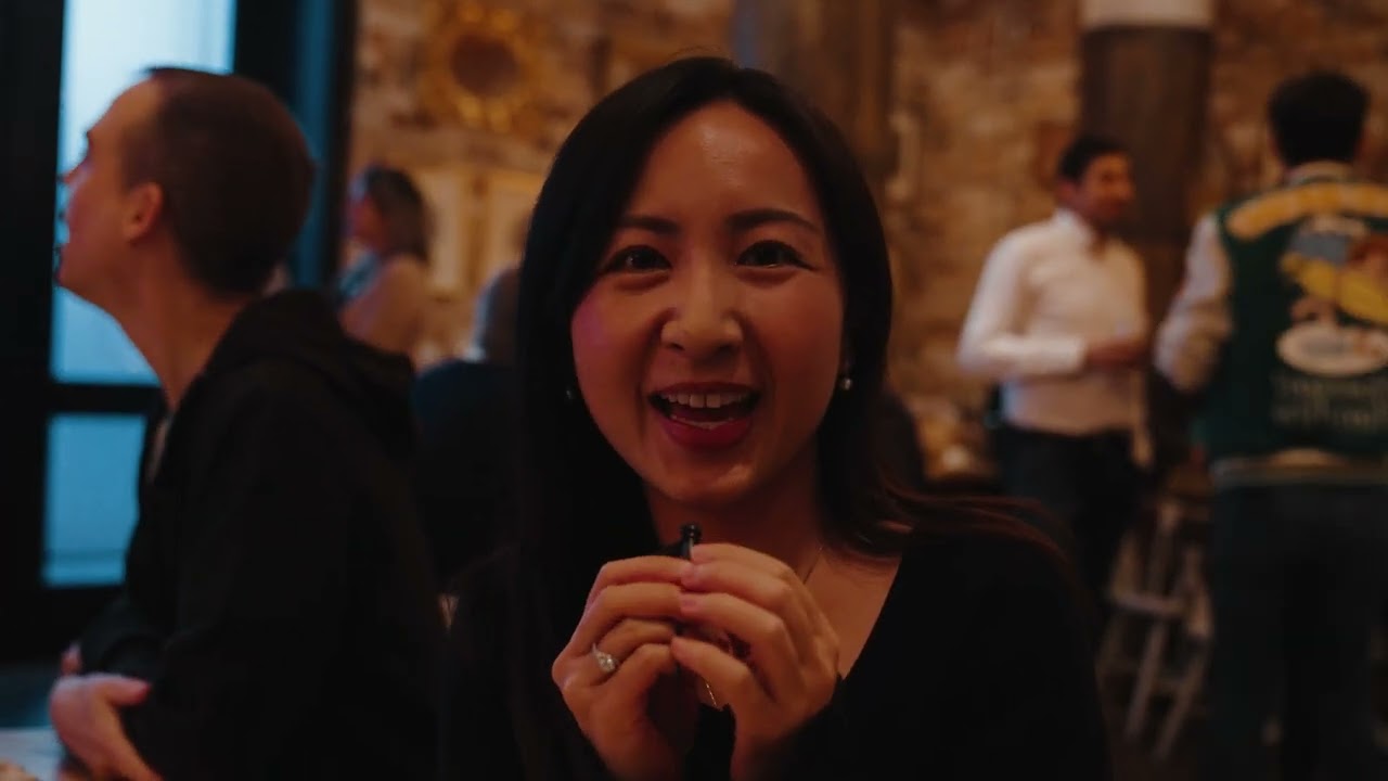 Woman smiling at corporate anniversary celebration event — milestone brand film video production by Origin Films Toronto